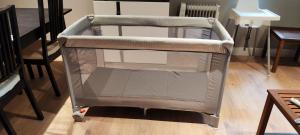 a baby cart in a room with a table at La Casita de Christian in Madrid
