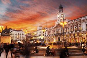 a painting of a city with a clock tower at La Casita de Christian in Madrid