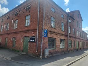 a brick building with a parking sign in front of it at kämpagatans bed and breakfast in Skara +7 photos