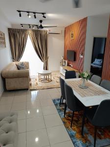 a living room with a table and a couch at FA Homestay Alanis, Near KLIA in Sepang