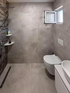 a bathroom with a toilet and a sink at Harasani apartments in Ulcinj +87 photos
