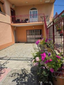 a house with a balcony and flowers in front of it at Stan Uljarević in Zlatište