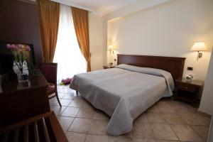 a hotel room with a bed and a window at Giò Hotel in Borgo Celano