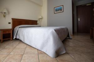 Ένα ή περισσότερα κρεβάτια σε δωμάτιο στο Giò Hotel