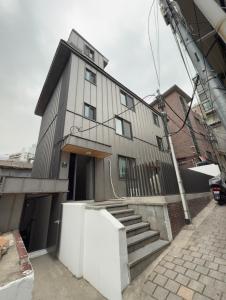 a large building with a staircase in front of it at Namsan Rooftop in Seoul