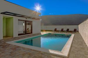 a swimming pool in the backyard of a house at Villa del Sol Mostar in Mostar