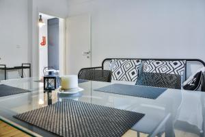 a living room with a glass table and a couch at Mata in Sveti Juraj