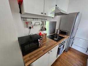 a small kitchen with a sink and a microwave at Flat in Hammersmith - Close to tube station in London