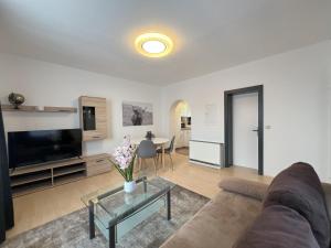 a living room with a couch and a tv at Apartment Theresa - LANDLUFT in Bad Aussee