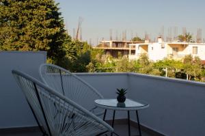 a small table and two chairs on a balcony at Harasani apartments in Ulcinj