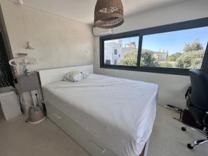 a bedroom with a white bed and a window at Luxury 6 bedroom 4 bathroom villa with pool in Vari +83 photos
