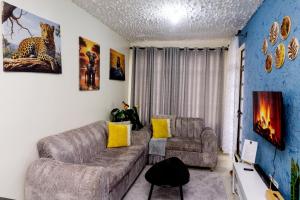 a living room with a couch and a chair at Naanyu Homestays in Nanyuki
