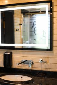 a bathroom sink with a large mirror above it at Busko Residence in Staryy Mizunʼ +69 photos