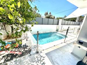 a swimming pool in the backyard of a house at Luxury 6 bedroom 4 bathroom villa with pool in Vari