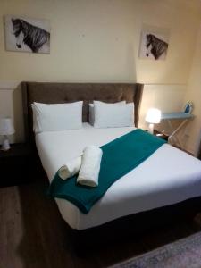 a bedroom with a large bed with two towels on it at Cozy comfort apartment in Lusaka +5 photos