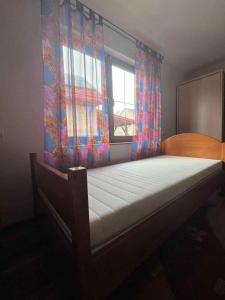 a bed in a room with a window and a bed frame at Agroturystyka Beskid Niski Dukla TERESA in Dukla