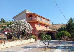 a large orange house with a balcony on a street at Casa Presenza in Santa Elisabetta