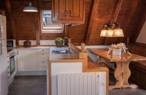 a kitchen with wooden cabinets and a wooden table at Eth Humarau de Ço de Bernat in Mont
