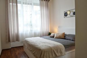 a bedroom with a bed in front of a window at Apartmán u Fontány in Poděbrady