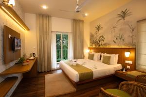 a hotel room with a bed and a desk at Bamboo Dale Resort & Spa Munnar by Stride in Munnar +67 photos
