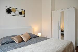 a bedroom with a bed and a picture on the wall at Apartmán u Fontány in Poděbrady