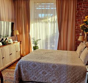 a bedroom with a bed and a window at CASA ALEX in Sărata-Monteoru