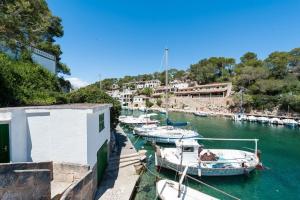 a group of boats are docked in a harbor at Can Joan in Cala Figuera