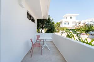 a balcony with two chairs and a table at Paloma Seaesta Cabanas in Rhodes Town