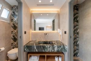 a bathroom with a sink and a toilet at Paloma Seaesta Cabanas in Rhodes Town