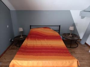 a bedroom with a bed with a colorful blanket on it at Chambre - Sdb Privative - Super Vue in Pallud