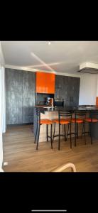 a kitchen with a table and chairs in a room at La Maison du Rond-Buisson in Maîche