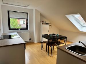 a small kitchen with a table and a refrigerator at Ferienwohnung Immenzaun in Isernhagen