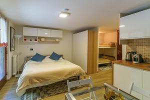 a bedroom with a bed with blue pillows on it at iFlat Appartamento Pineta in Breuil-Cervinia