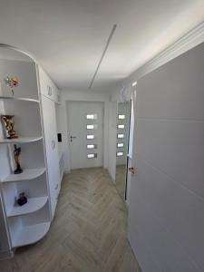 a room with a hallway with white walls and a door at Green Home Bihać in Bihać