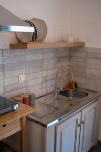 a kitchen with a sink and a counter top at Stella's Apartments in Nea Skioni