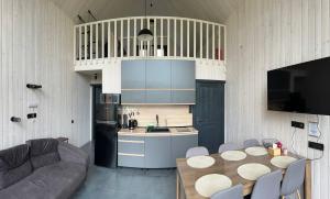 a kitchen and living room with a table and a couch at Карпати Плай Village in Bukovel