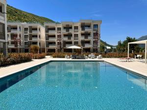 a swimming pool in front of a apartment building at River side 18 in Herceg-Novi