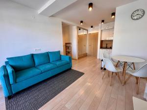 a living room with a blue couch and a table at River side 18 in Herceg-Novi