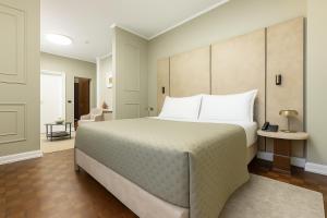 Postel nebo postele na pokoji v ubytování Hotel Majestic
