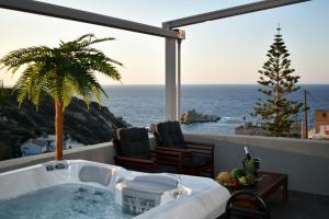 a bath tub with a view of the ocean at D&A Luxury suite with private Jacuzzi in Ligaria