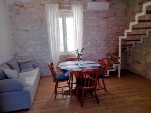 a living room with a table and a couch at Appartment Brani & Mira in Rukavac +14 photos