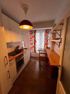 a kitchen with a counter and a table in it at Vivienda Sol in Ferrol