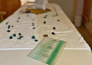 a table topped with white towels with blue rocks on it at Riad Dar Timrad in Fez