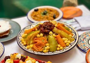 a table with plates of food on a table at Riad Dar Timrad in Fez