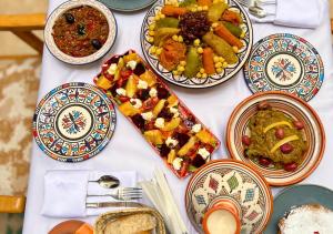 a table with many plates of food on it at Riad Dar Timrad in Fez
