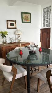 a dining room with a glass table with two candles on it at Casa Alina in Antigua Guatemala +18 photos