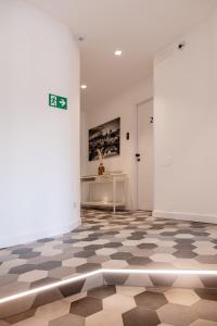 a room with a checkered floor and a white door at Flora Guest House in Rome