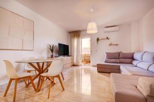 a living room with a table and a couch at Anna del Mar Coastal Boho in San Luis de Sabinillas