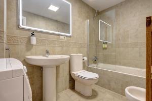 a bathroom with a toilet and a sink and a tub at Anna del Mar Coastal Boho in San Luis de Sabinillas +17 photos