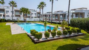 an image of a swimming pool in a yard with palm trees at Mirador del Mar in Torrevieja